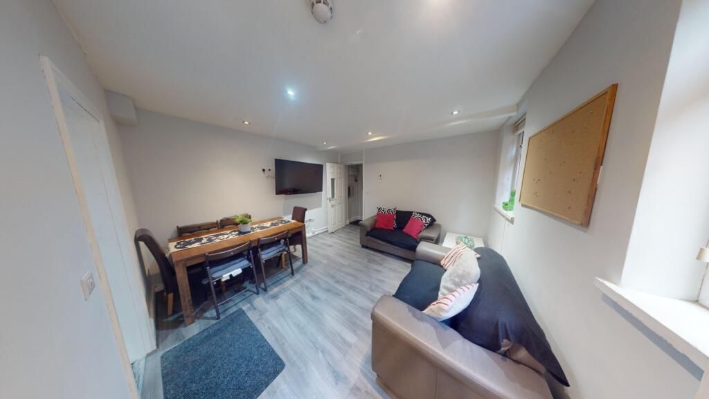 Property photo 2 of 11 A Cozy And Modern Living Room Featuring Comfortabl...