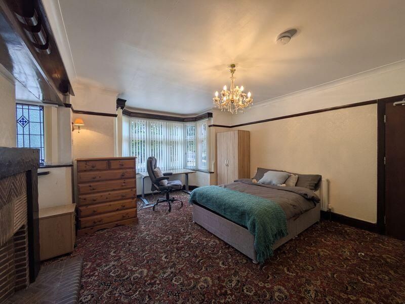 Property photo 2 of 15 A Spacious And Well-Lit Bedroom Featuring A Large ...