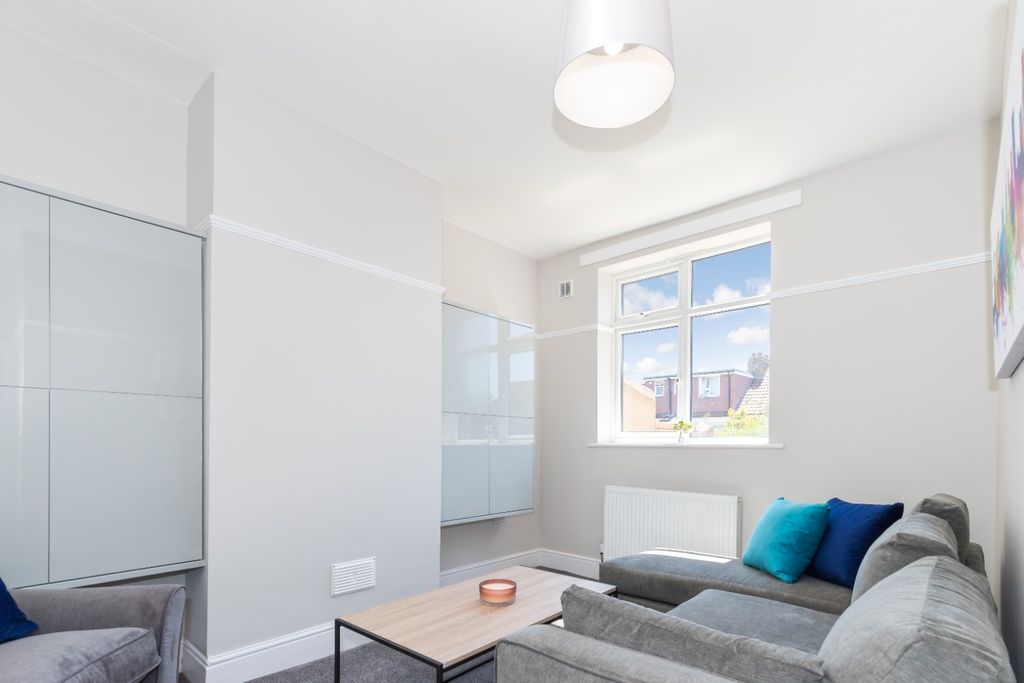 Property photo 1 of 14 A Bright And Inviting Living Room Featuring Modern...