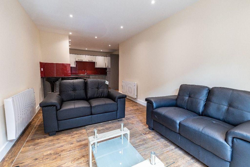Property photo 2 of 10 A Modern Living Room Featuring Two Comfortable Dar...