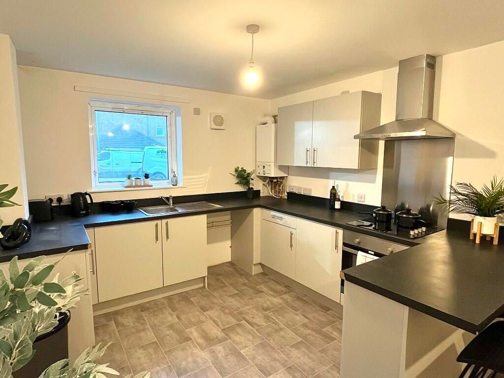 Property photo 2 of 8 Bright And Modern Kitchen Featuring Ample Counter ...