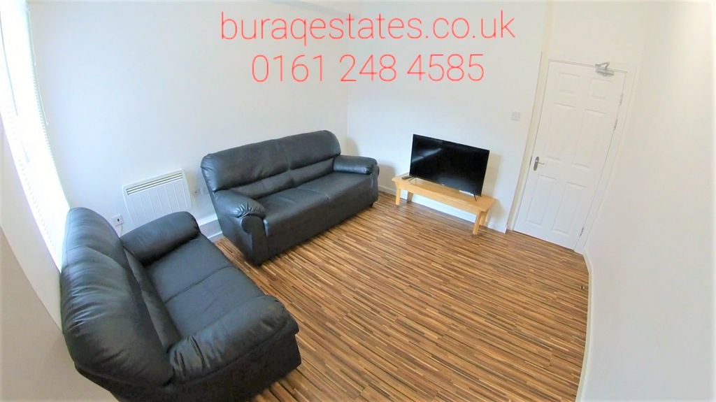 Property photo 2 of 13 A Neat And Welcoming Living Room Featuring Two Bla...