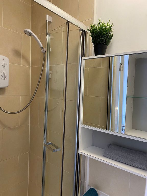 Property photo 3 of 21 This Modern Bathroom Features A Sleek Glass Shower...