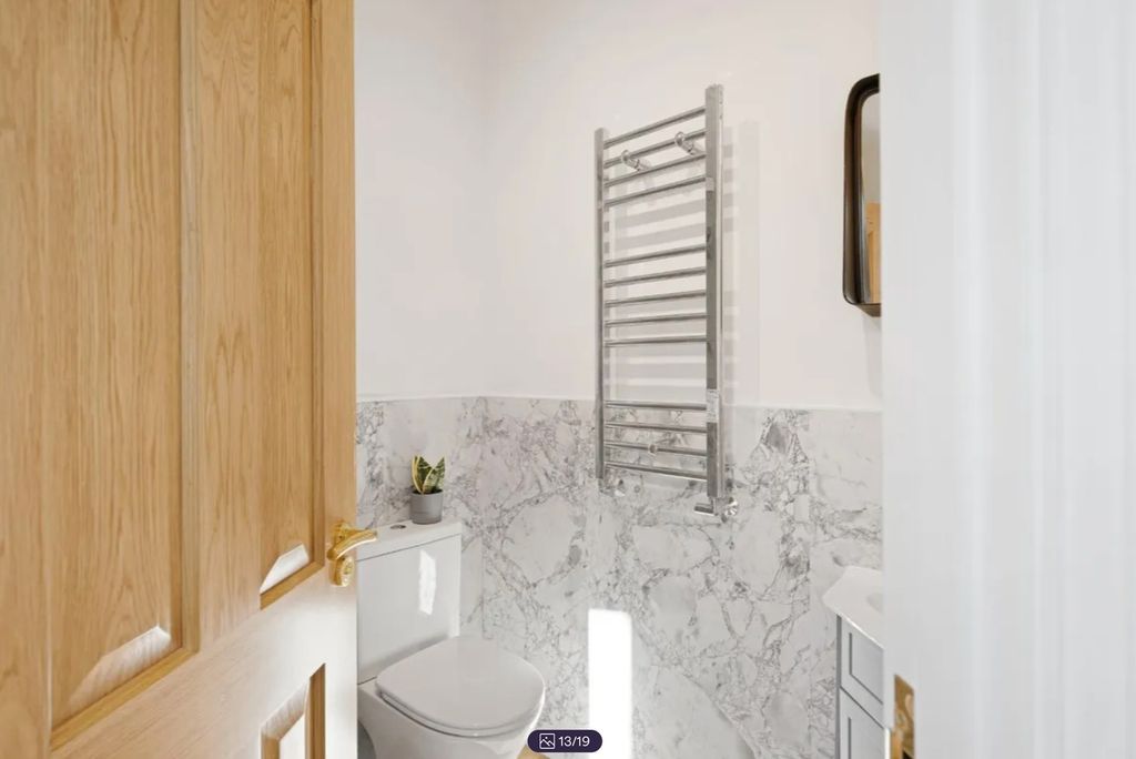 Property photo 3 of 19 A Modern And Clean Bathroom Featuring Stylish Marb...