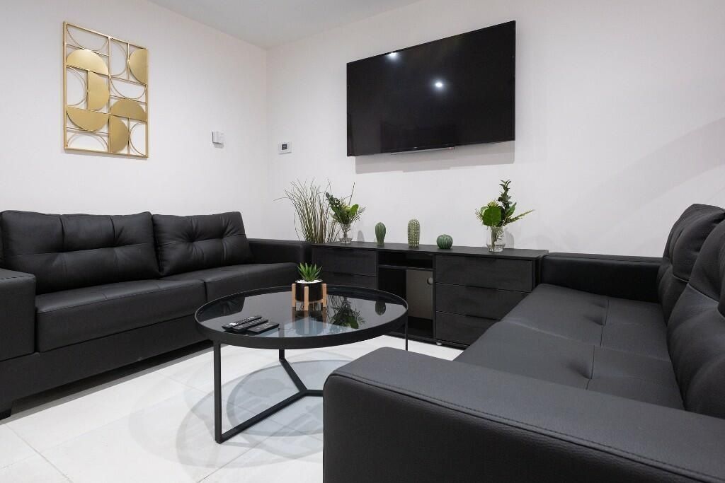 Property photo 3 of 15 Contemporary Lounge With Matching Black Sofas Arra...