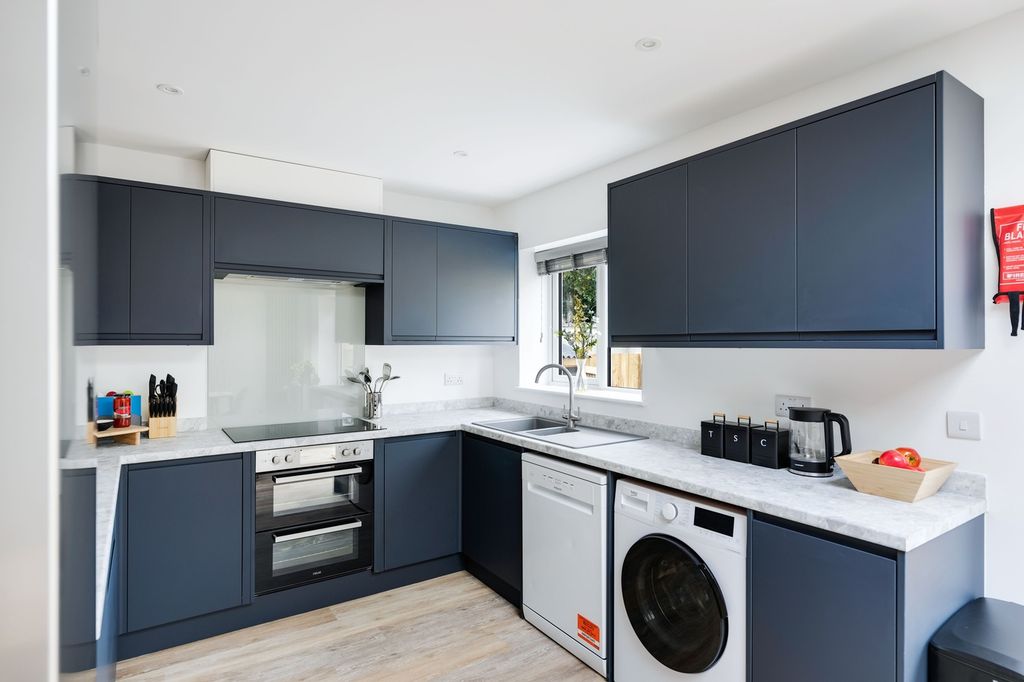 Property photo 1 of 19 A Modern And Spacious Kitchen With Sleek Cabinetry...