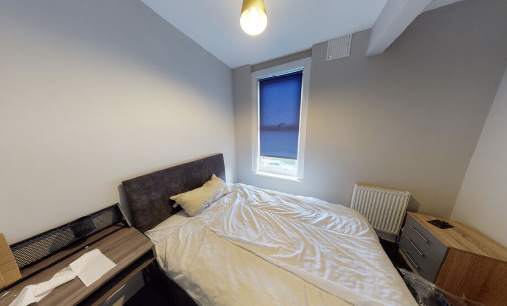 Property photo 2 of 12 A Bright, Well-Maintained Bedroom Featuring A Comf...