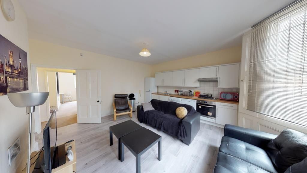 Property photo 1 of 8 A Bright And Modern Living Room Featuring Stylish ...