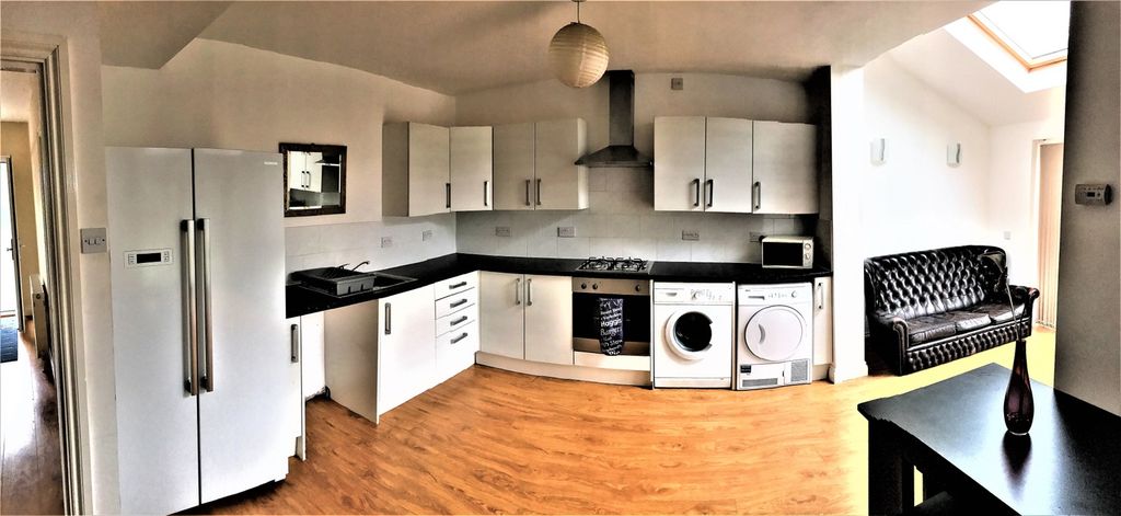 Property photo 3 of 9 Spacious And Modern Kitchen Featuring Sleek White ...