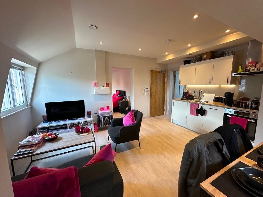 Property photo 3 of 10 A Modern, Well-Lit Living Room Featuring Light Woo...
