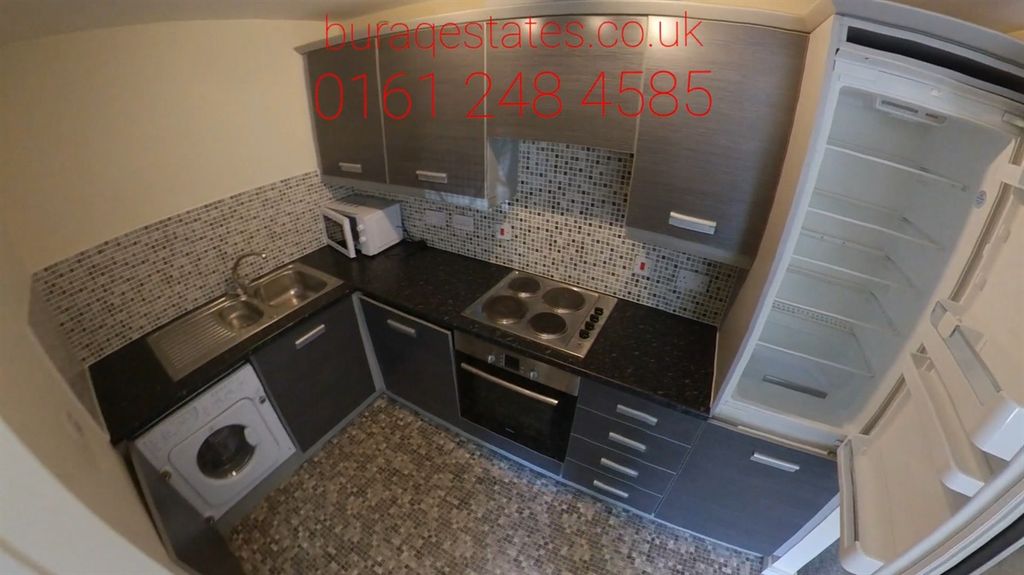 Property photo 3 of 11 Compact Modern Kitchen With Dark Cabinetry, Tiled ...