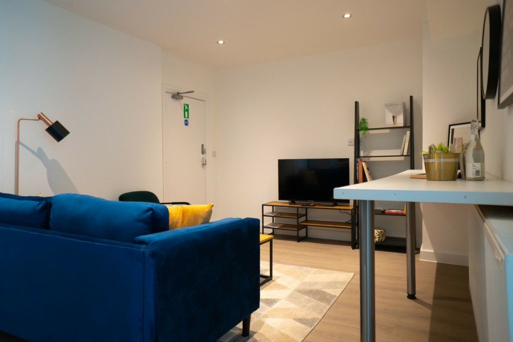 Property photo 3 of 10 A Modern, Well-Lit Living Room Featuring A Vibrant...