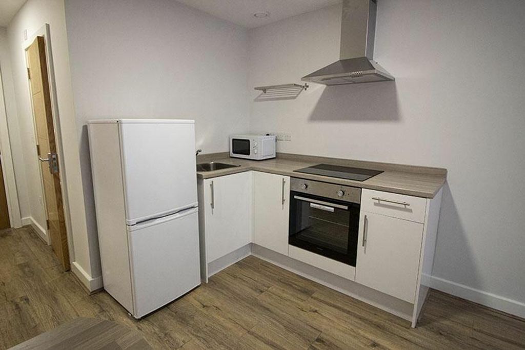 Property photo 3 of 4 Modern Kitchen Featuring Sleek Cabinetry, Essentia...