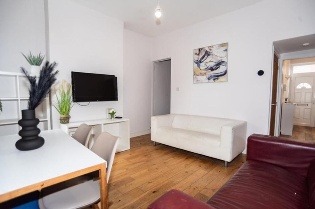 Property photo 3 of 9 Stylish And Inviting Living Room Featuring Ample N...