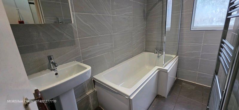 Property photo 3 of 9 Modern Bathroom With Sleek Grey Tiling And Bath...