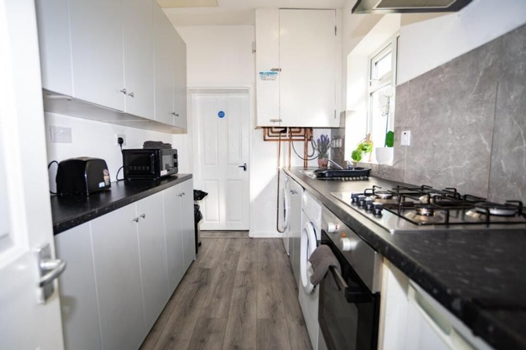 Property photo 3 of 12 This Modern Kitchen Features Sleek Cabinetry And A...