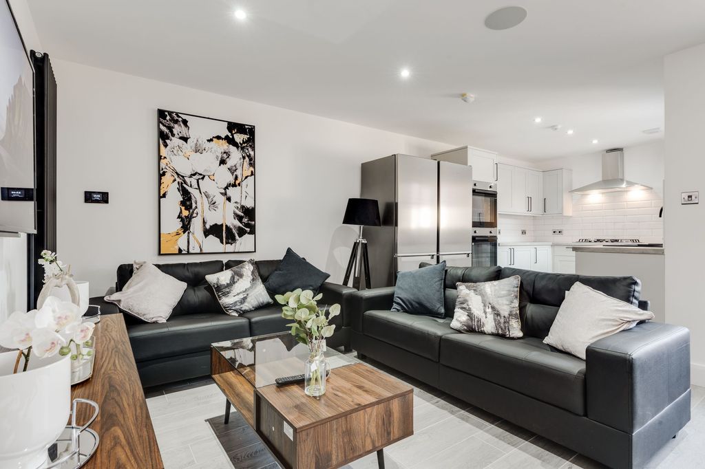 Property photo 2 of 7 A Modern, Bright Living Room Featuring Plush Black...