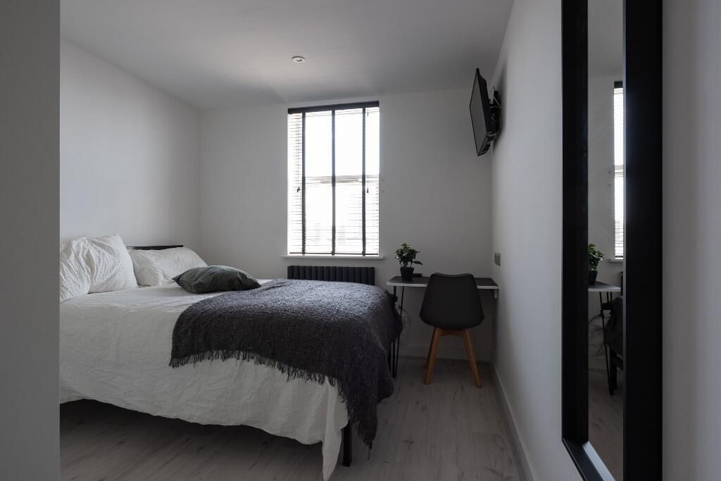 Property photo 2 of 14 A Spacious And Tidy Bedroom Featuring A Large Bed,...
