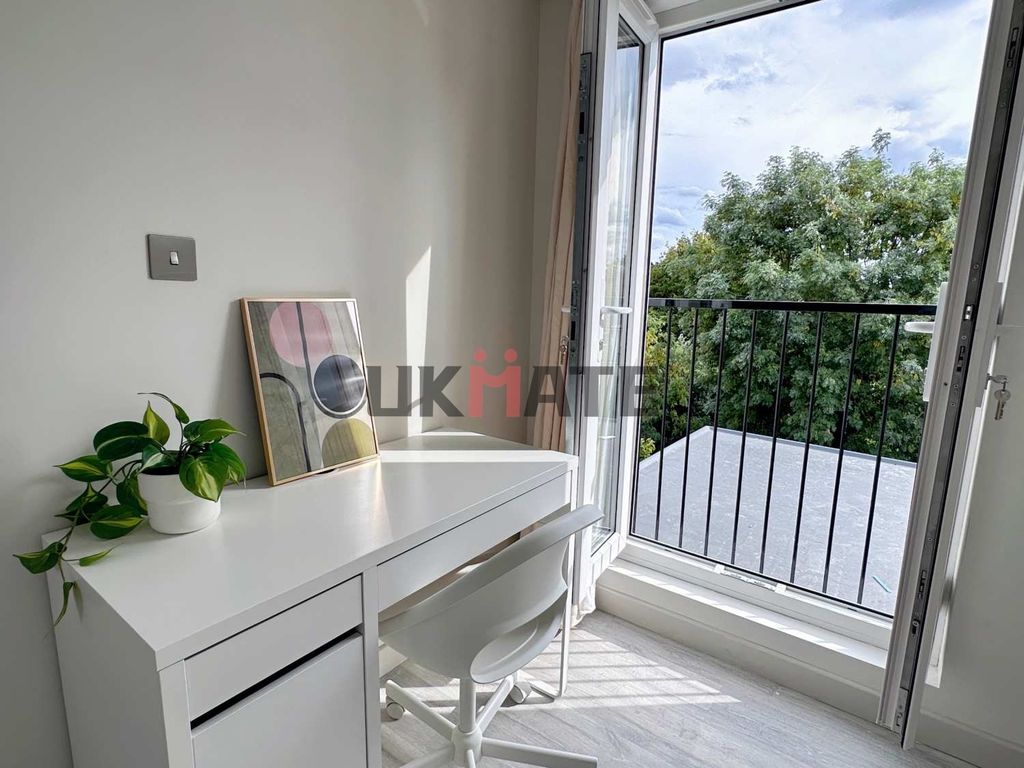 Property photo 1 of 5 A Bright And Airy Bedroom Featuring A Sleek White ...