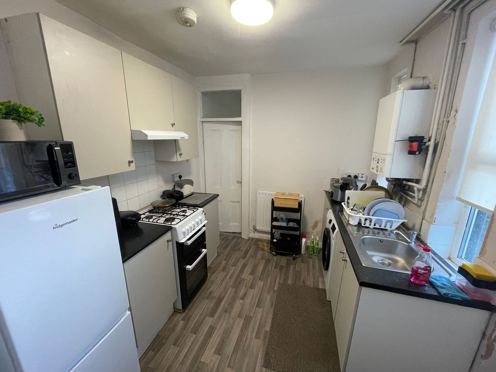 Property photo 2 of 5 Bright Galley-Style Kitchen With Fitted Cabinets, ...