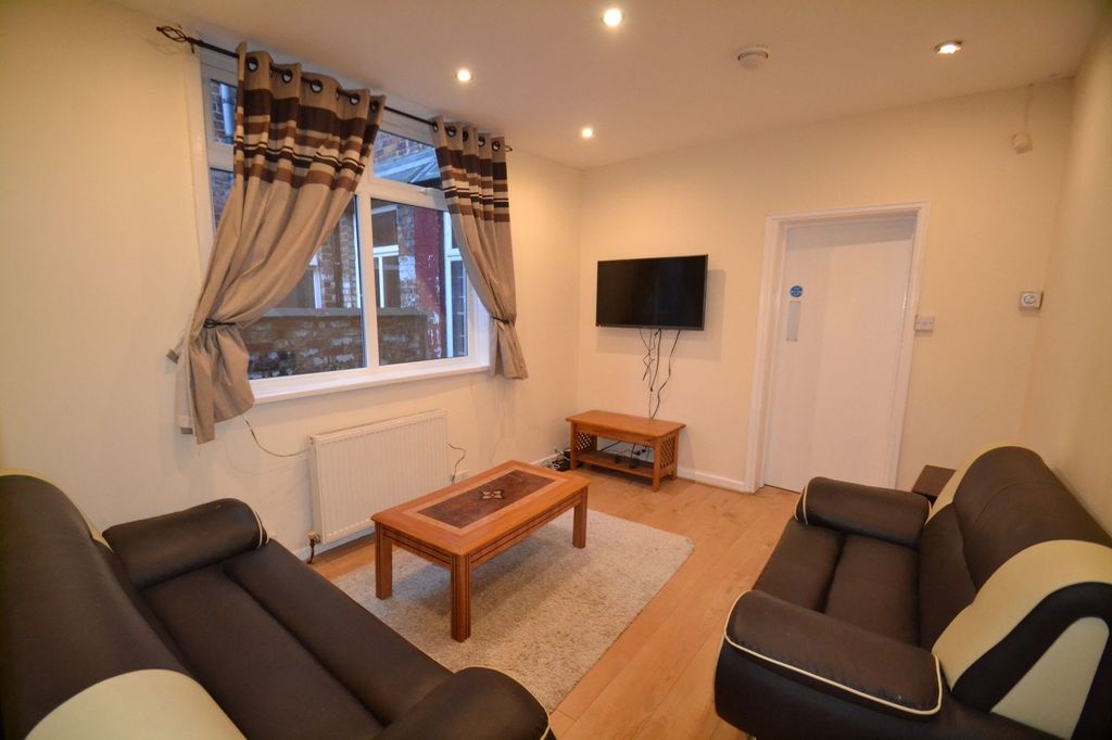 Property photo 1 of 27 A Bright And Inviting Living Room Featuring Two Co...