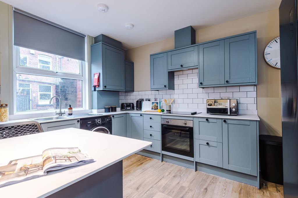 Property photo 3 of 6 Modern Kitchen With Blue Cabinetry And Island...