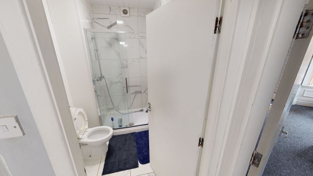 Property photo 3 of 7 Bright And Modern Bathroom Featuring A Glass-Enclo...