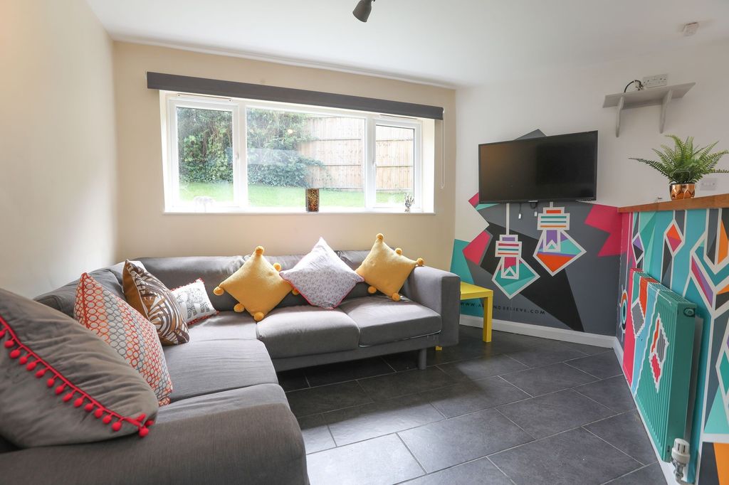 Property photo 1 of 4 This Cozy Living Room Features A Stylish Grey Sofa...