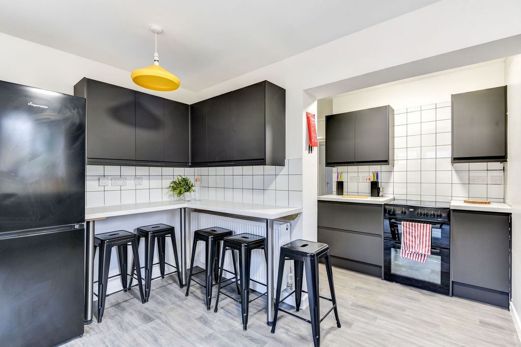 Property photo 1 of 5 Modern Kitchen Featuring Sleek Black Cabinetry And...