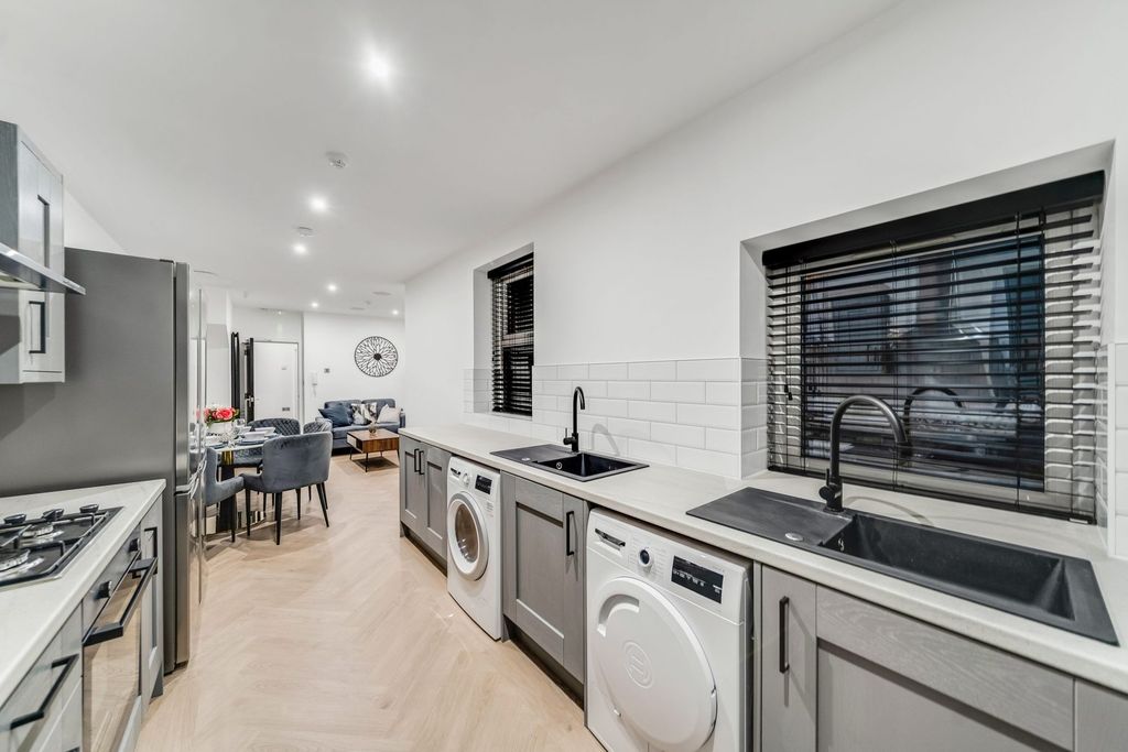 Property photo 1 of 10 Modern, Well-Lit Kitchen Featuring Twin Sinks, Amp...