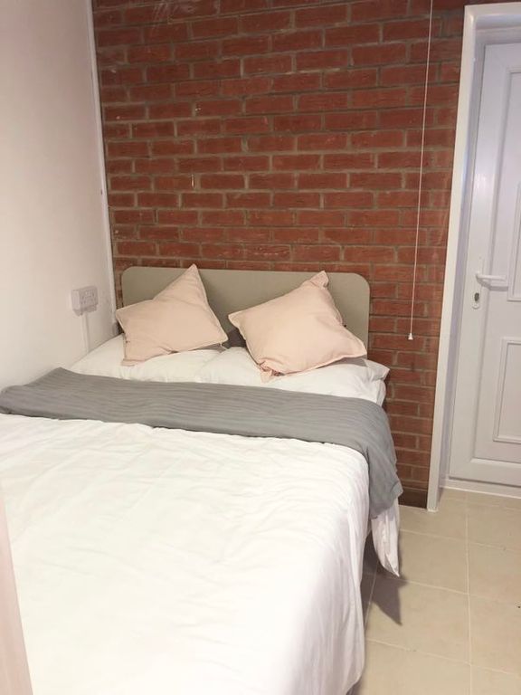 Property photo 2 of 6 Bright, Neatly Made Bedroom With Exposed Brick Fea...
