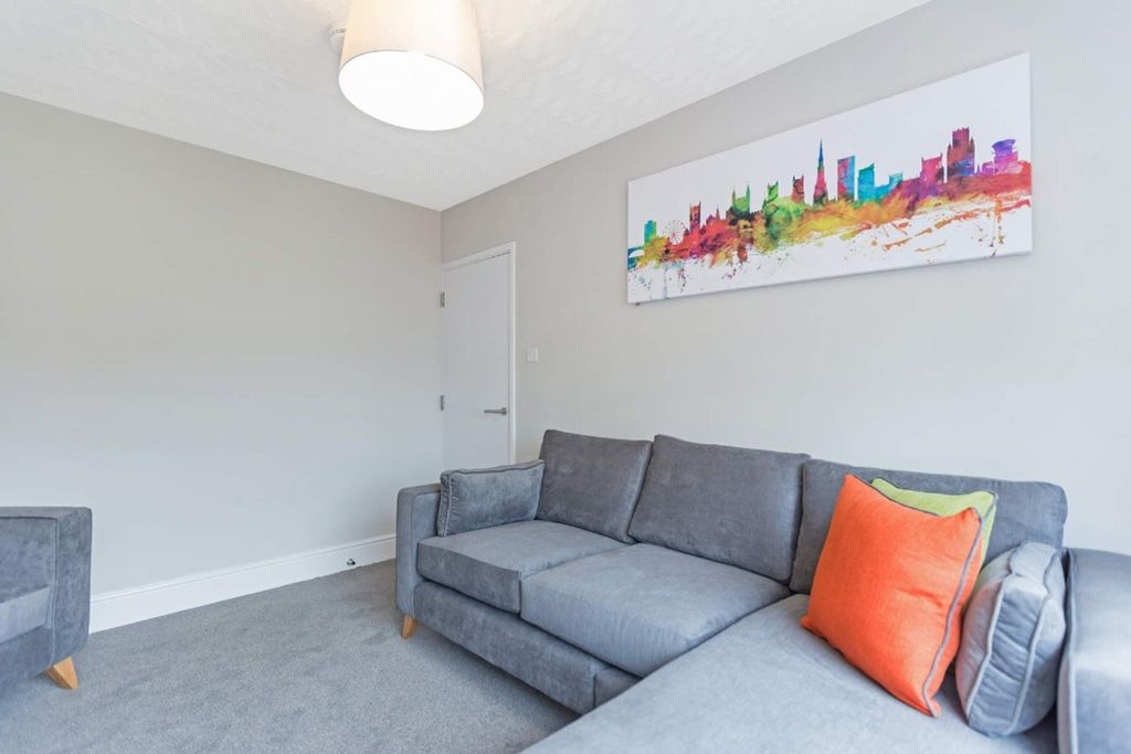 Property photo 3 of 13 A Stylish And Inviting Living Room Featuring Comfo...
