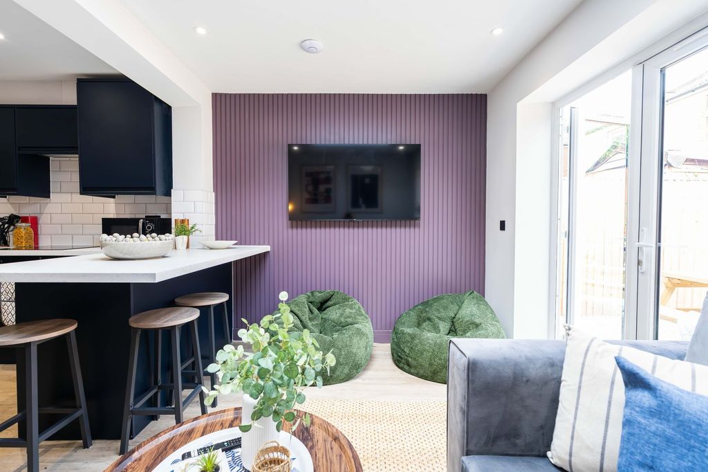 Property photo 3 of 46 A Bright And Modern Living Room Featuring Large Wi...