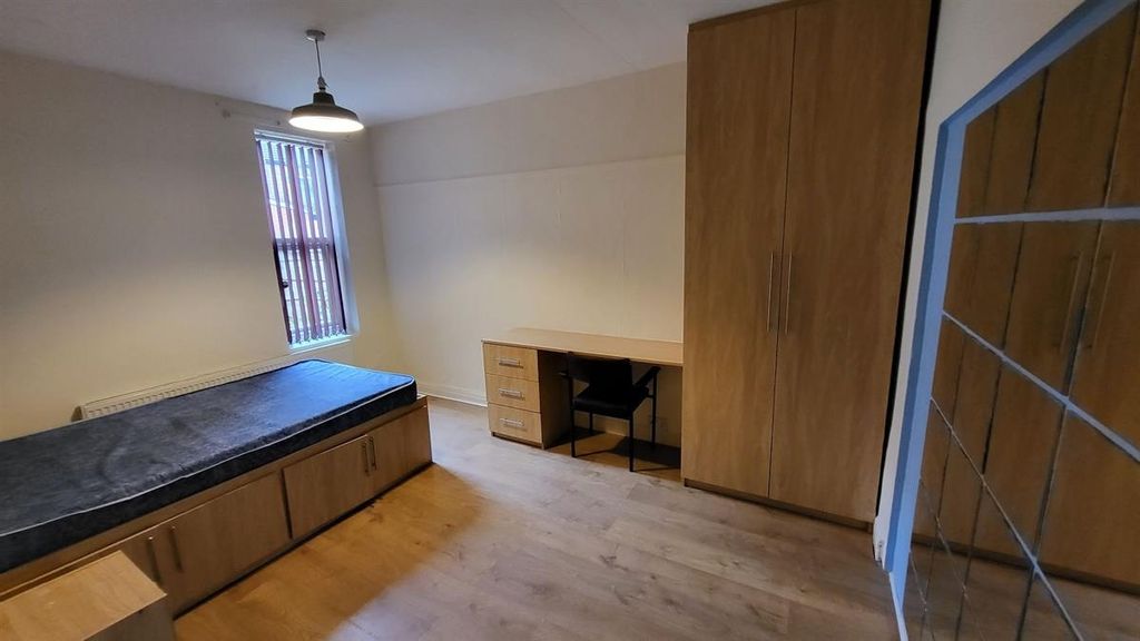 Property photo 2 of 13 A Bright And Well-Maintained Bedroom Featuring A l...