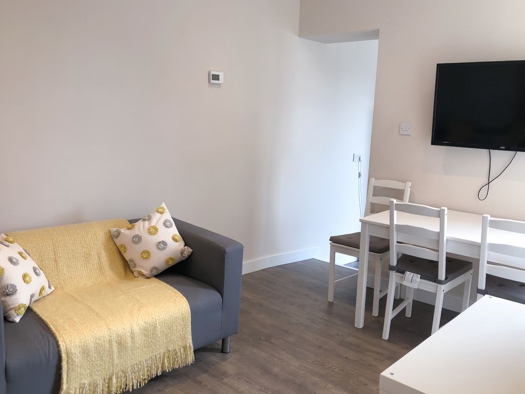 Property photo 3 of 9 A Cozy And Inviting Living Room Featuring A Comfor...