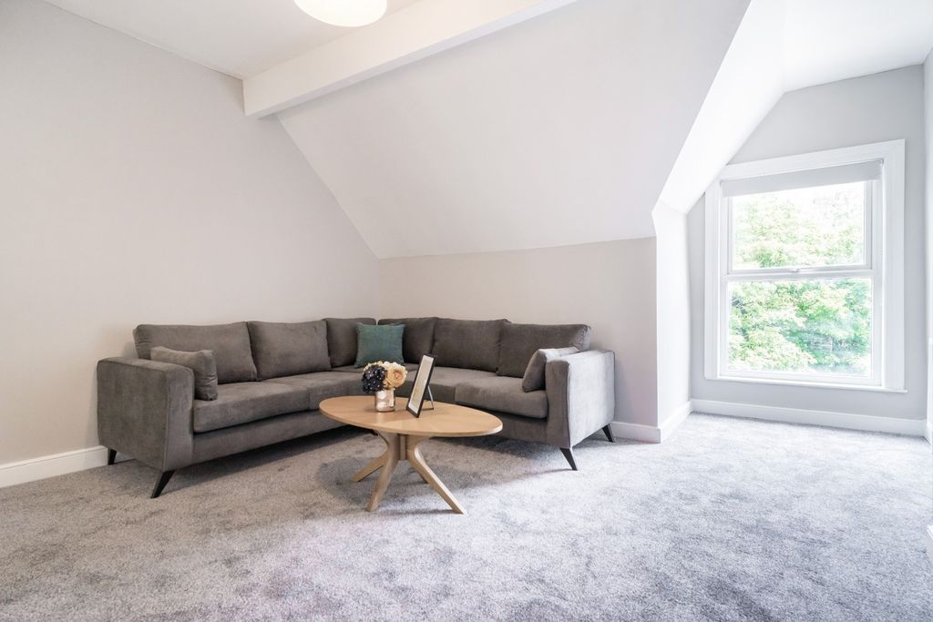 Property photo 2 of 15 This Inviting Living Room Features A Cozy Gray Sof...