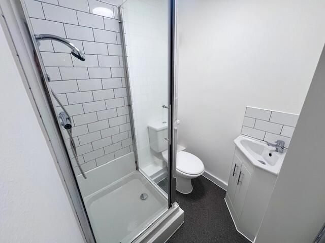 Property photo 2 of 9 Compact And Modern Bathroom Featuring A Glass-Encl...