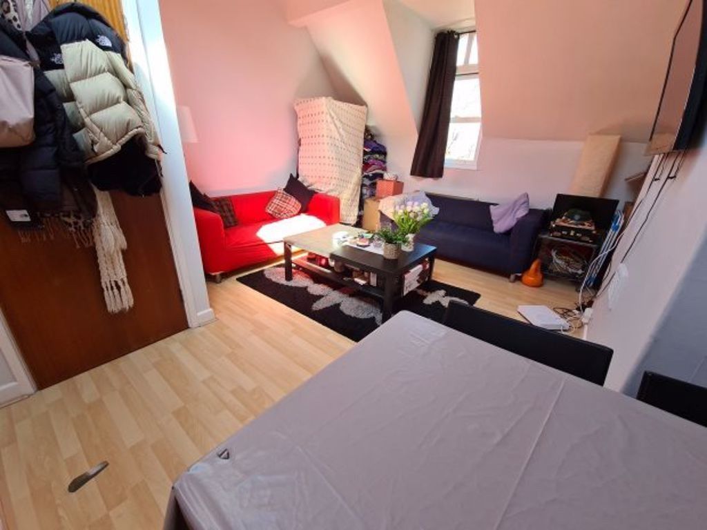 Property photo 3 of 7 A Cozy Living Room Featuring A Red Sofa, Coffee Ta...