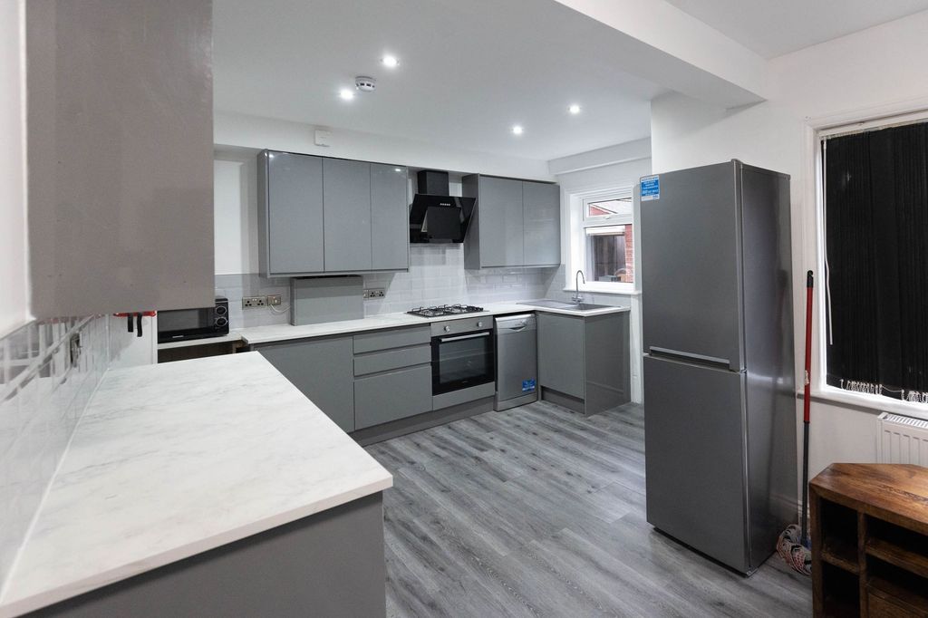 Property photo 1 of 9 Modern And Sleek Kitchen With Grey Cabinetry, Whit...