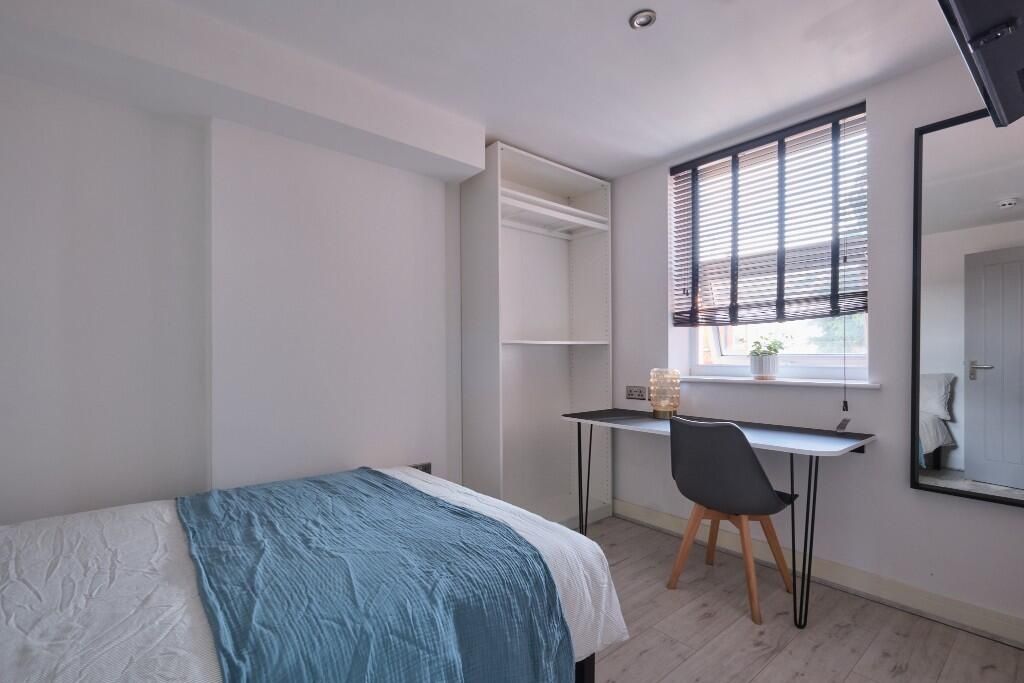 Property photo 3 of 15 A Bright And Cozy Bedroom Featuring A Comfortable ...