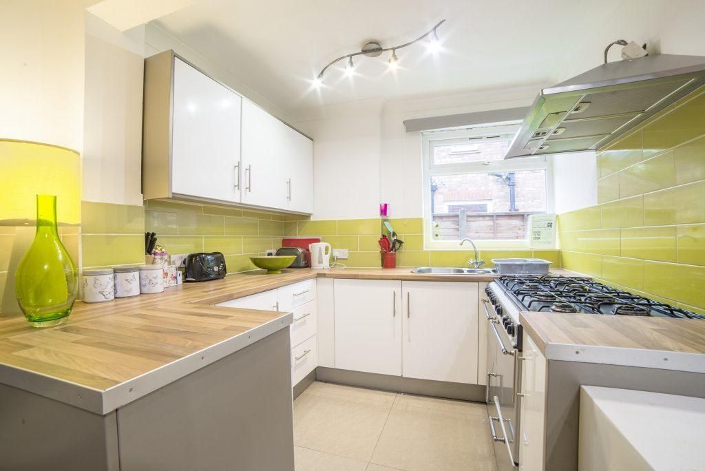 Property photo 2 of 3 Modern Galley Kitchen With White Cabinets, Light W...