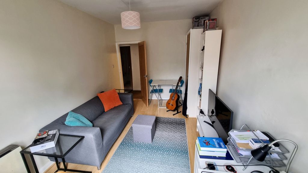 Property photo 3 of 6 A Cozy Living Room Featuring A Modern Grey Sofa Wi...