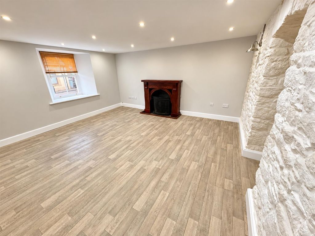 Property photo 2 of 14 Renovated Living Room With Stone Accent.Png