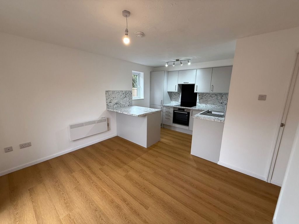 Property photo 1 of 8 Modern Kitchen Featuring Sleek White Cabinets, Mar...