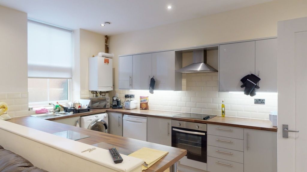 Property photo 2 of 6 Bright And Modern Kitchen Featuring Sleek Cabinetr...
