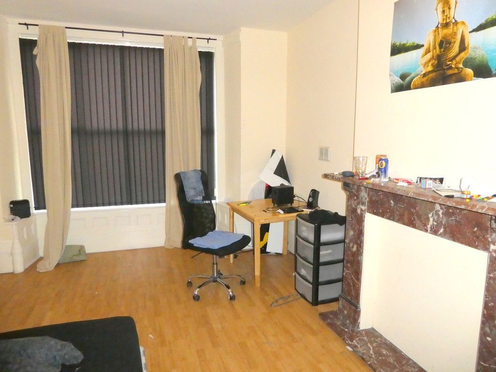 Property photo 1 of 7 A Bright And Inviting Living Room Featuring A Comf...