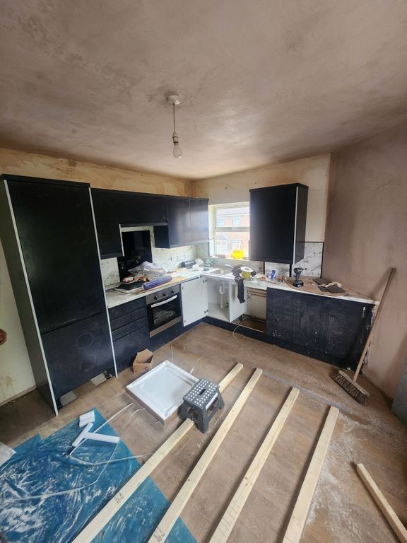 Property photo 1 of 6 A Kitchen Space Featuring Modern Black Cabinetry A...