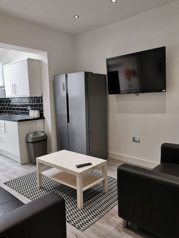 Property photo 2 of 21 A Modern And Inviting Living Room Featuring A Well...