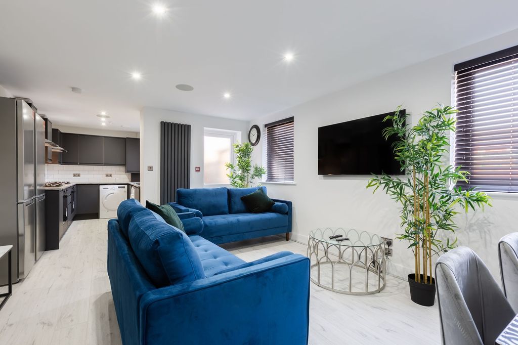 Property photo 1 of 7 A Modern And Spacious Living Room Featuring Vibran...