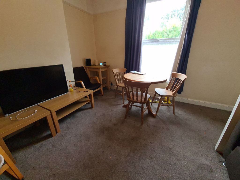 Property photo 1 of 17 A Cozy Living Room Featuring A Large Window Allowi...